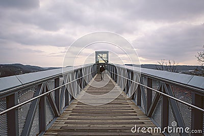 Deep perspective of man walking towards outdoor elevator. Stock Photo