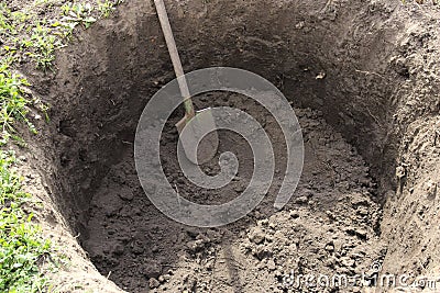 Deep pit in the ground. Digging a hole. Stock Photo
