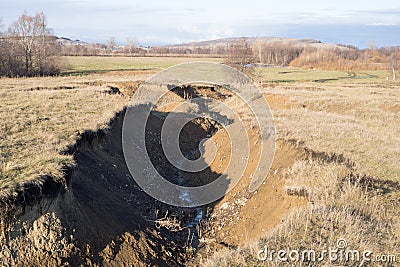 Deep ravine due to soil erosion. Stock Photo