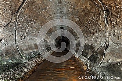 Deep sewage tunnel with poinson flowing Stock Photo