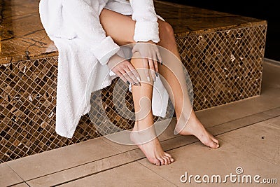 Deep vein thrombosis and varicose of woman. Girl touching her legs and looking at veins. Sclerotherapy procedure at Stock Photo