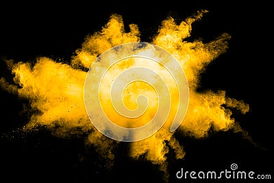 Deep Yellow color powder explosion cloud isolated on black background Stock Photo