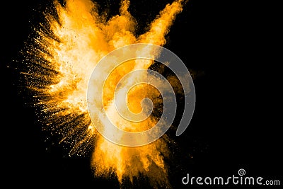 Deep Yellow color powder explosion cloud isolated on black background Stock Photo