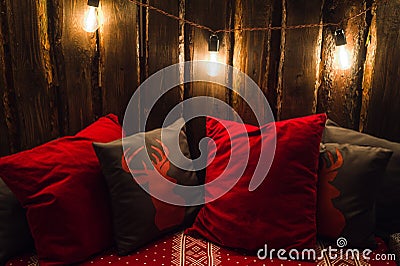 Deer head on red hand made pillow wooden background in interior Stock Photo