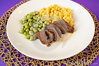 Deer meat, boiled broad bean and semolina pasta Stock Photo