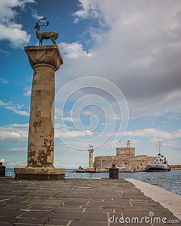 The deer of Rhodes in the entrance of the port Editorial Stock Photo