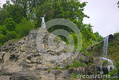 A deer statue near waterfall Stock Photo