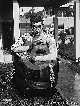 Defeated boxer in barrel outside Stock Photo