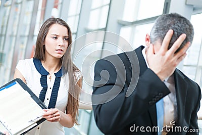 Defeated businessman turns away form coworker Stock Photo