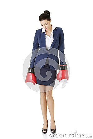 Defeated businesswoman in boxing gloves Stock Photo