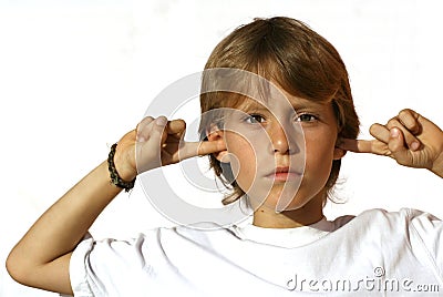 defiant child fingers in ear Stock Photo