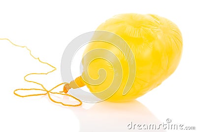 Deflated yellow balloon at a rope Stock Photo