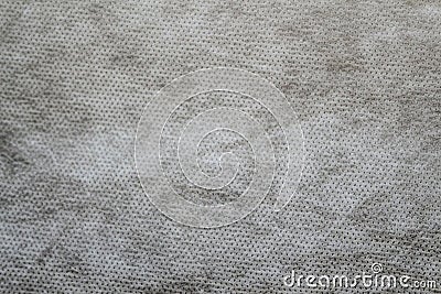 Defocus grey spunbond non-woven geotextile close-up macro. Small spots. Dirtied texture. Design, background, backdrop. Out of Stock Photo