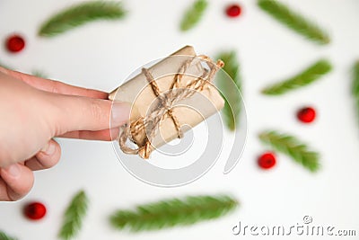 Defocus hand holding eco gift. White fir background. Woman hands opening gift box. Christmas, new year, birthday concept Stock Photo