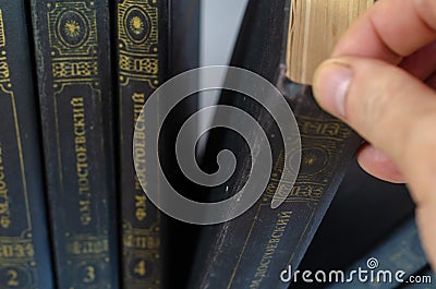 Defocus, noise, blur, grain effect. A man takes a book by Fyodor Editorial Stock Photo