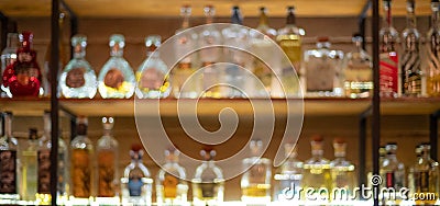 Defocused background of bar counter with various bottles of alcohol Stock Photo