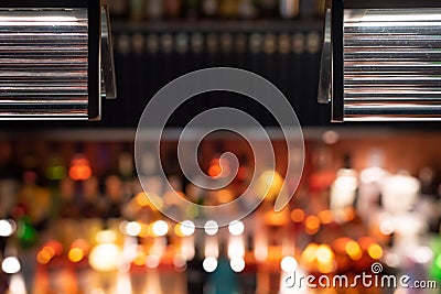 Defocused bar counter with backlit bottles in the background Stock Photo