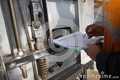 Defocused of building maintenance services inspector holding paperwork checkinglist pen conducting faulty daily inspecting Stock Photo