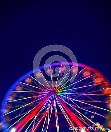 Defocused ferris wheel with colorful lights Stock Photo