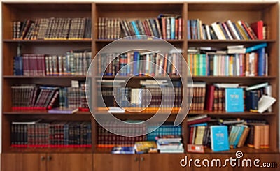 Defocused image. Multi-colored books on the bookshelf in the library. The bokeh effect Stock Photo