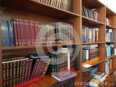 Defocused image. Multi-colored books on the bookshelf in the library. The bokeh effect Stock Photo