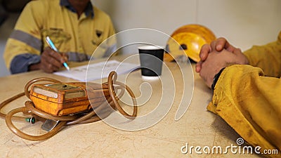 Construction worker Asian hand written Job Hazard Analysis JHA risk assessment on the table Stock Photo