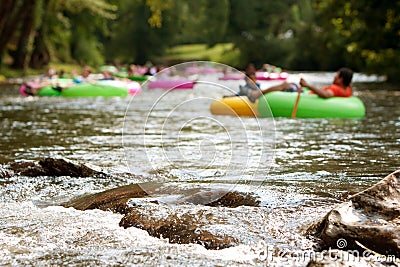 Defocused People Tubing Down River Approach Boulders In Focus Editorial Stock Photo