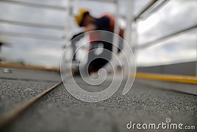 Engineer conducting using pull machinery testing chemical set fall arrest fall restraint abseiling anchor point Stock Photo