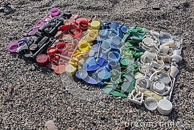 Degraded still life of plastic caps and different plastic pieces found on the beach Stock Photo