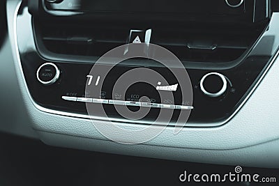 71-degree high temperature setting with knobs, digital display inside modern car, defrost mode with fan at full blast for defogger Stock Photo