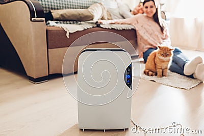 Dehumidifier with touch panel, humidity indicator, uv lamp, air ionizer, water container works at home. Dampness Stock Photo