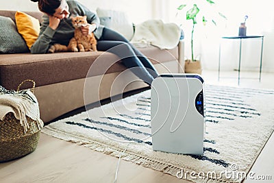 Dehumidifier with touch panel, humidity indicator, uv lamp, air ionizer, water container works at home. Air dryer Stock Photo