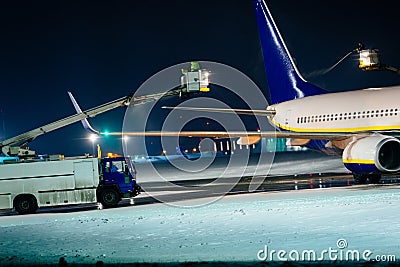 Deicing passenger airplane during heavy snow Stock Photo