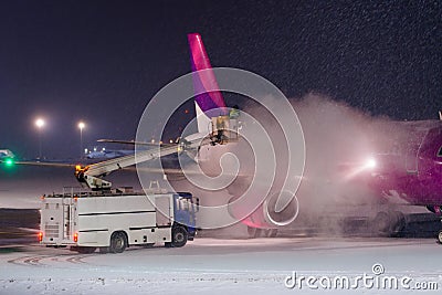 Deicing plane with glycol Editorial Stock Photo