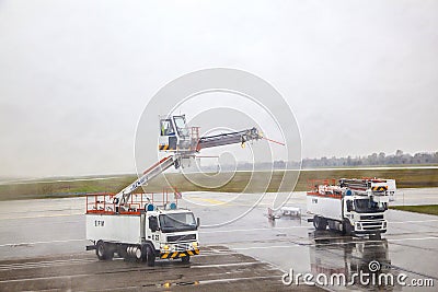 Deicing truck deices a plane before Editorial Stock Photo