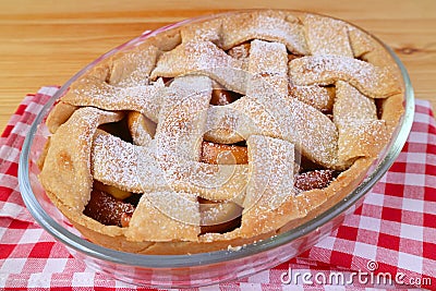 Delectable fresh baked homemade tasty and healthy apple pie on checker kitchen cloth Stock Photo