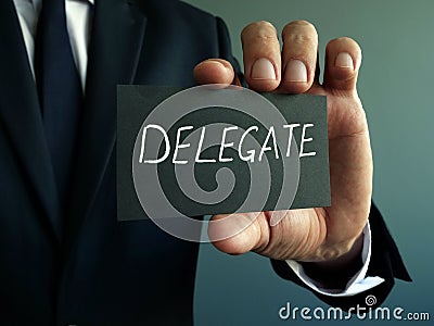 Delegate sign in the hands of the businessman. Delegation concept Stock Photo