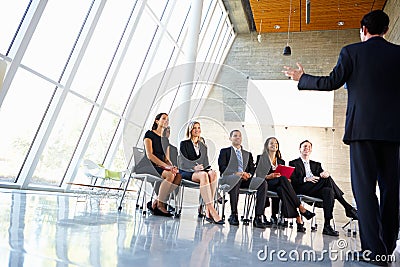 Delegates Listening To Speaker Stock Photo