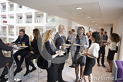 Delegates Networking During Conference Lunch Break Stock Photo