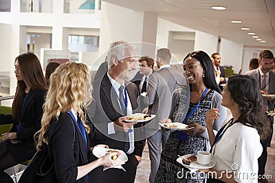 Delegates Networking During Conference Lunch Break Stock Photo