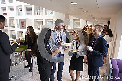 Delegates Networking During Conference Lunch Break Stock Photo