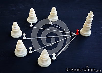 Delegation and management. Pawns and chess king Stock Photo