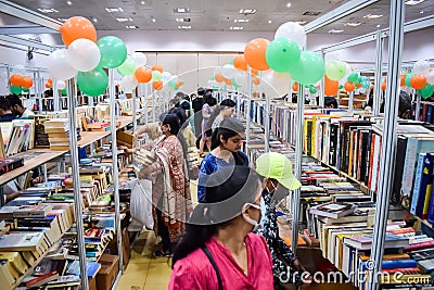 Delhi, India, February 17 2024 - Various age group people reading variety of Books on shelf inside a book-stall at Delhi Editorial Stock Photo