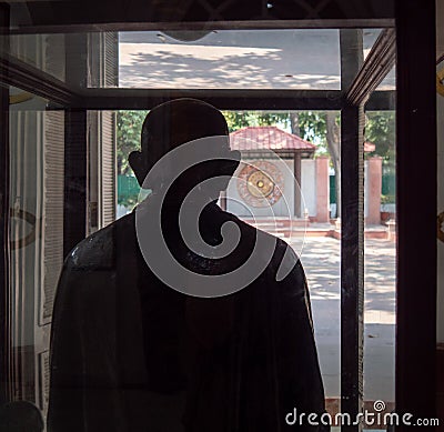 DELHI, INDIA - MARCH 15, 2019: statue mahatma gandi facing the window of the house he walked through on the day he was Editorial Stock Photo