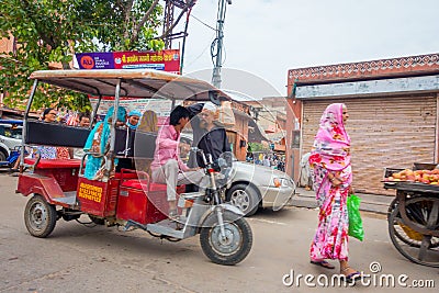 DELHI, INDIA - SEPTEMBER 19, 2017: Autorickshaw red in the street, paharganj. there are many tourist stay in this area Editorial Stock Photo