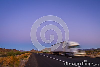 Deliberately blurred 18 wheel long haul truck on highway in desert Stock Photo