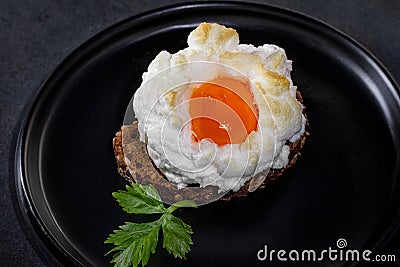 Delicate baked egg Orsini eggs in the cloud. French breakfast Stock Photo