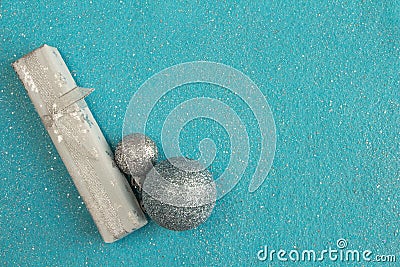 delicate christmas composition,gift and christmas balls on blue felt background with sparkles, copy space Stock Photo