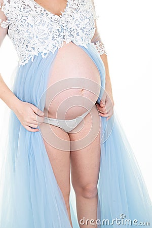 Delicate elegant pregnant woman in a white blue dress Stock Photo