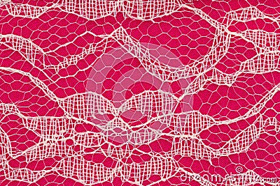 Delicate lace textured material on bright pink knit background Stock Photo